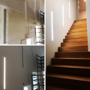 Treppenhaus mit vertikal integrierten LED-Lichtlinien im Trockenbau, realisiert mit KIZAR20 Unterputzprofil